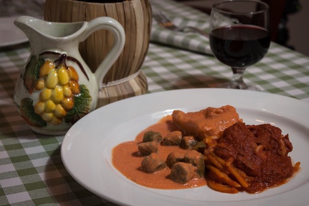 Plate of colorful italian pasta with a glass of wineの写真素材