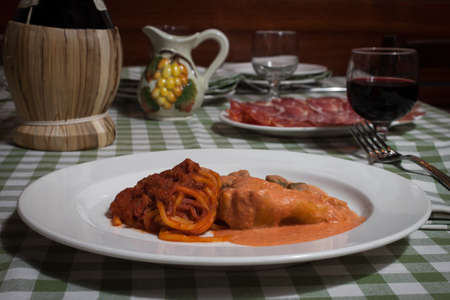 Plate of colorful italian pasta with a glass of wineの写真素材