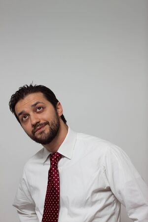 Portrait of a young bearded man with red tieの写真素材