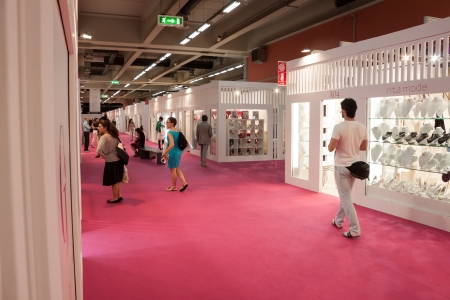 MILAN, ITALY - JUNE 21: People visit SposaItalia exhibition, international presentation of bridal and formal wear according to Italian style in Milan on JUNE 21, 2013.のeditorial素材