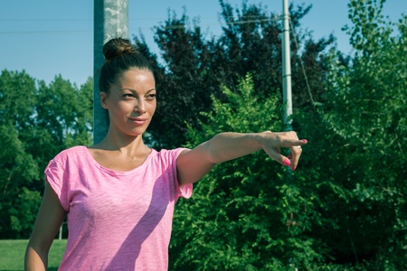 Portrait of a beautiful girl pointing her finger の写真素材