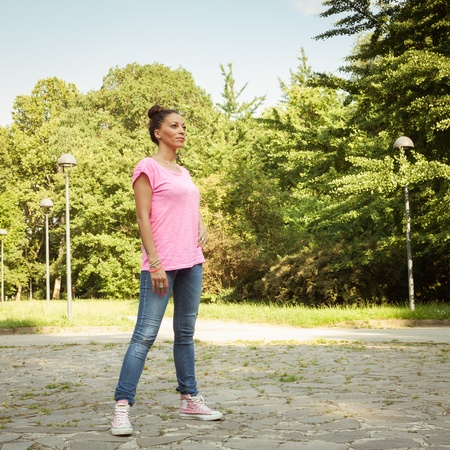 Portrait of a beautiful girl standing in city parkの写真素材