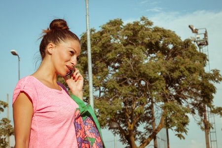 Portrait of a beautiful girl with casual look talking on phoneの写真素材
