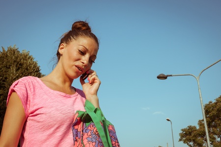 Portrait of a beautiful girl with casual look talking on phoneの写真素材