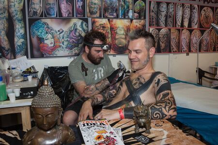 MILAN, ITALY - JUlY 6: People visit Tatuami, important event dedicated to the world of tattoos in Milan on JUlY 6, 2013のeditorial素材