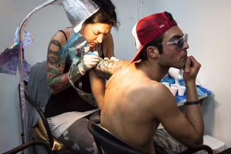 MILAN, ITALY - JUlY 6: People visit Tatuami, important event dedicated to the world of tattoos in Milan on JUlY 6, 2013のeditorial素材
