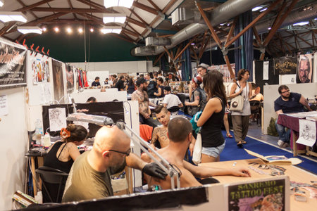 MILAN, ITALY - JUlY 6: People visit Tatuami, important event dedicated to the world of tattoos in Milan on JUlY 6, 2013のeditorial素材