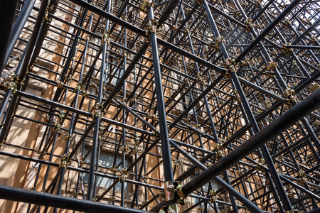 Architectural detail of scaffolding pipes shoring up a damaged buildingの写真素材