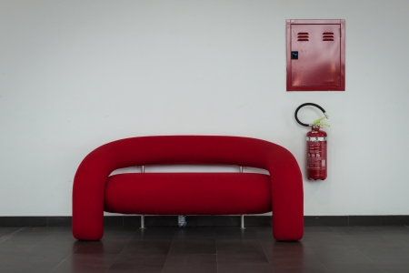 MILAN, ITALY - OCTOBER 3  Red couch with fire extinguisher at Made expo, international architecture and building trade show on October 3, 2013 in Milan のeditorial素材
