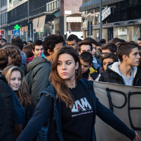 MILAN, ITALY - OCTOBER 11  Secondary school students march in the city streets to protest against money cuts in the public school on October 11, 2013 in Milan のeditorial素材