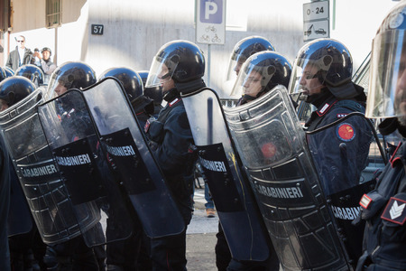 MILAN, ITALY - OCTOBER 11  Riot police confronts secondary school students marching in the city streets to protest against money cuts in the public school on October 11, 2013 in Milan のeditorial素材
