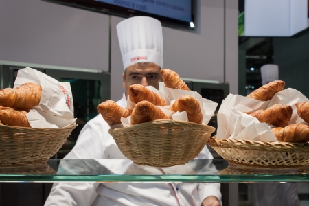 MILAN, ITALY - OCTOBER 18  A cook with his sweet rolls at Host 2013, international exhibition of the hospitality industry on OCTOBER 18, 2013 in Milan のeditorial素材