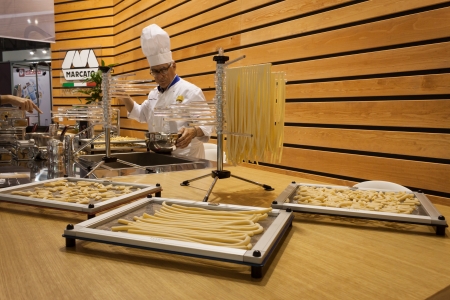 MILAN, ITALY - OCTOBER 18  Cook prepares handmade pasta at Host 2013, international exhibition of the hospitality industry on OCTOBER 18, 2013 in Milan のeditorial素材