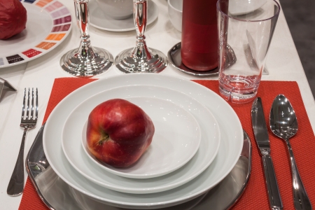 MILAN, ITALY - OCTOBER 18  Tableware with red apple Host 2013, international exhibition of the hospitality industry on OCTOBER 18, 2013 in Milan のeditorial素材