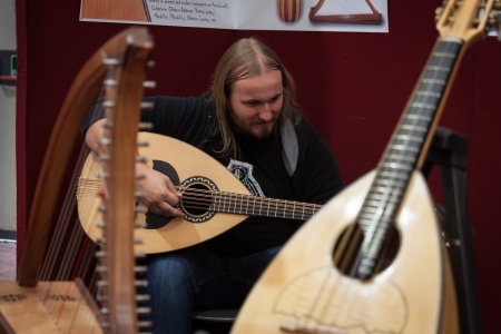 MILAN, ITALY - OCTOBER 20: A musician plays mandoloncello at Milano Guitars & Beyond 2013, important trade show of string instruments with specific attention to guitars on OCTOBER 20, 2013 in Milan.のeditorial素材
