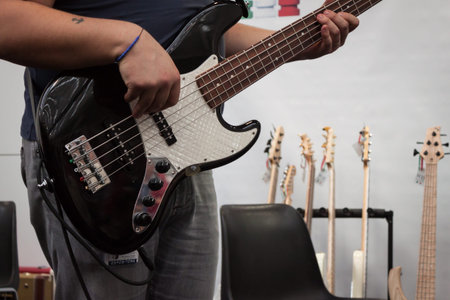 MILAN, ITALY - OCTOBER 20  Musician plays bass guitar at Milano Guitars   Beyond 2013, important...