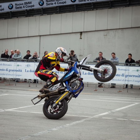 MILAN, ITALY - NOVEMBER 7  Trial pilot rides on rear wheel at EICMA, international motorcycle exhibition on NOVEMBER 7, 2013 in Milan のeditorial素材