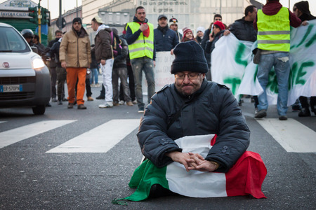 MILAN, ITALY - DECEMBER 13: Demonstrators occupy the city streets blocking the traffic to protest against government and politicians on DECEMBER 13, 2013 in Milan.のeditorial素材