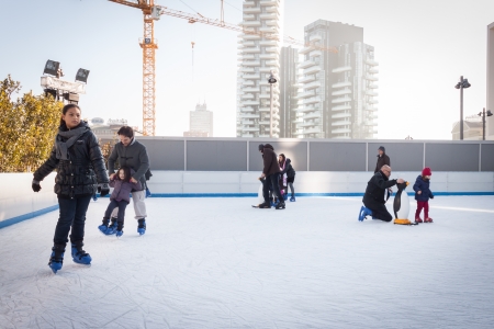 MILAN, ITALY - DECEMBER 27: People have fun skating on a public ice rink built up in the city streets by Municipality during the Christmas period on DECEMBER 27, 2013 in Milan.のeditorial素材