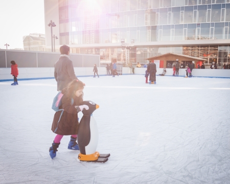 MILAN, ITALY - DECEMBER 27: People have fun skating on a public ice rink built up in the city streets by Municipality during the Christmas period on DECEMBER 27, 2013 in Milan.のeditorial素材