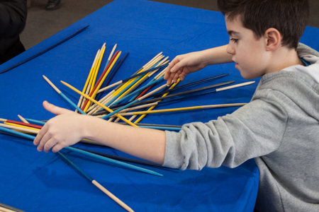 MILAN, ITALY - FEBRUARY 2: Young boy plays shanghai at Festival del Fumetto, convention dedicated to...