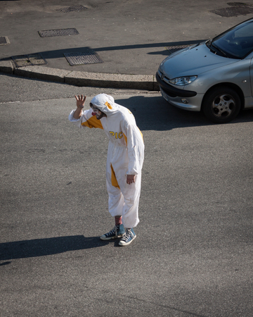 MILAN, ITALY - MARCH 5: Clown stands in the middle of the street at Milan Clown Festival, international event dedicated to clowns and street theatre on MARCH 5, 2014 in Milan.のeditorial素材