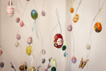 Colorful Easter eggs hanging on white branches