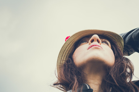 Portrait of a pretty girl with long hair and hatの写真素材