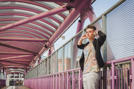 Pretty short hair girl with black jacket listening to music on a bridge