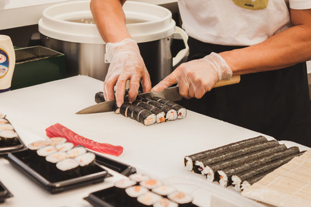 MILAN, ITALY - APRIL 27: Sushi rolls preparation at Orient Festival, event dedicated to Oriental culture and traditions on APRIL 27, 2014 in Milan.のeditorial素材