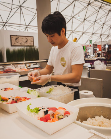 MILAN, ITALY - APRIL 27: Sushi rolls preparation at Orient Festival, event dedicated to Oriental culture and traditions on APRIL 27, 2014 in Milan.のeditorial素材