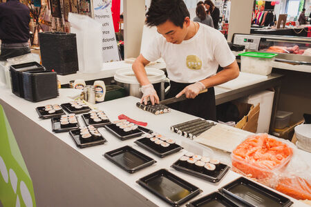 MILAN, ITALY - APRIL 27: Sushi rolls preparation at Orient Festival, event dedicated to Oriental culture and traditions on APRIL 27, 2014 in Milan.のeditorial素材