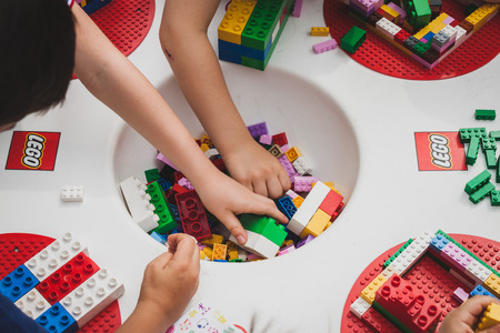 MILAN, ITALY - MAY 10: Children play at Lego Village, event held in the city streets to promote creativity and manual ability on MAY 10, 2014 in Milan.のeditorial素材
