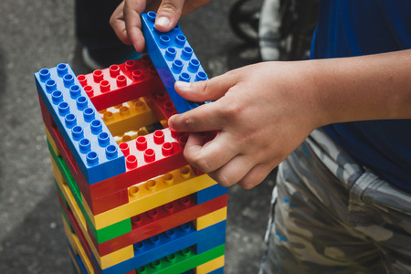 MILAN, ITALY - MAY 10: Child plays at Lego Village, event held in the city streets to promote creativity and manual ability on MAY 10, 2014 in Milan.のeditorial素材
