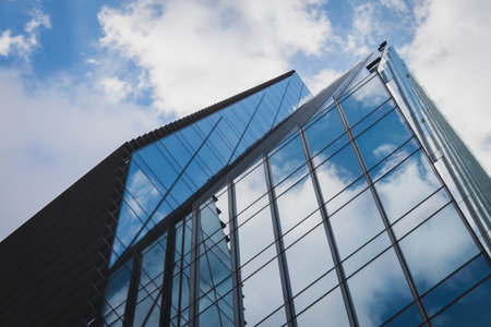 Architectural detail of a modern building against blue sky with clouds