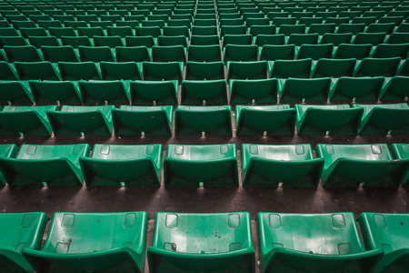 Perspective of many empty green stadium seatsの写真素材