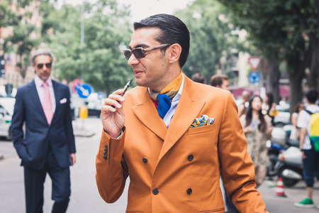 MILAN, ITALY - JUNE 23  People gather outside Armani fashion shows building for Milan Men Fashion Week on JUNE 23, 2014 in Milan のeditorial素材