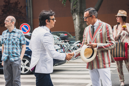 MILAN, ITALY - JUNE 23  People gather outside Armani fashion shows building for Milan Men Fashion Week on JUNE 23, 2014 in Milan のeditorial素材