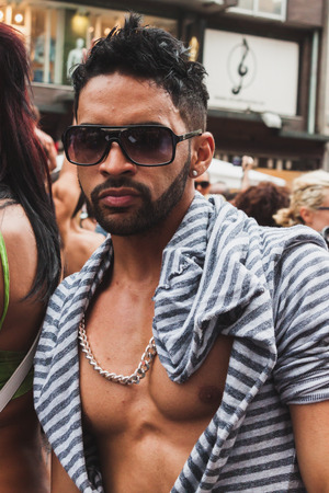 MILAN, ITALY - JUNE 28: People at gay pride parade in Milan JUNE 28, 2014. Thousands of people march in the city streets for the annual gay pride parade, claiming equality and legal rights. のeditorial素材