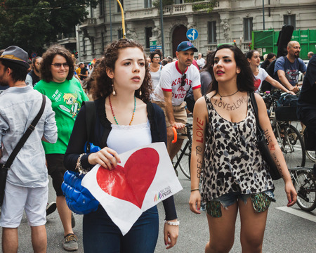 MILAN, ITALY - JUNE 28: People at gay pride parade in Milan JUNE 28, 2014. Thousands of people march in the city streets for the annual gay pride parade, claiming equality and legal rights. のeditorial素材