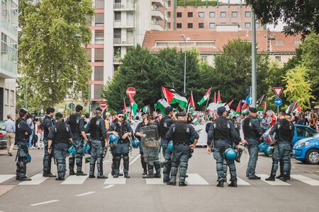 MILAN, ITALY - JULY 26: Riot police follows people marching and protesting against Gaza strip bombing in solidarity with Palestinians on JULY 26, 2014 in Milan.のeditorial素材