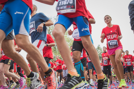 MILAN, ITALY - OCTOBER 5: Athletes take part in Deejay Ten, running event organized by Deejay Radio through the city streets on OCTOBER 5, 2014 in Milan.のeditorial素材