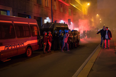 MILAN, ITALY - OCTOBER 11: Demonstrators launch smoke canisters to police in front of the Turkish consulate while asking help for Kurdish people in Syria on OCTOBER 11, 2014 in Milan.のeditorial素材