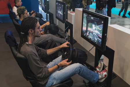 MILAN, ITALY - OCTOBER 24: People play at Games Week 2014, event dedicated to video games and electronic entertainment on OCTOBER 24, 2014 in Milan.のeditorial素材