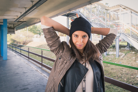 Pretty girl with beanie posing in a metro stationの写真素材