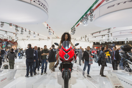 MILAN, ITALY - NOVEMBER 5: Beautiful model poses at EICMA, international motorcycle exhibition on NOVEMBER 5, 2014 in Milan.のeditorial素材