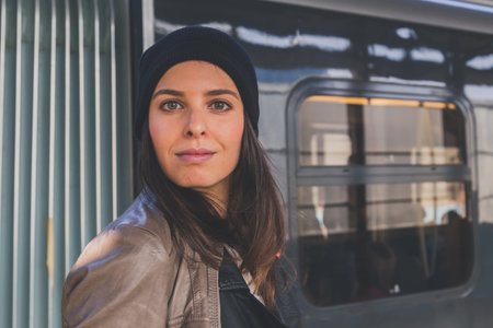 Pretty girl with beanie posing in a metro stationの写真素材
