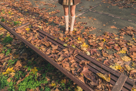 Detail of a young woman with long hair posing in a city parkの写真素材