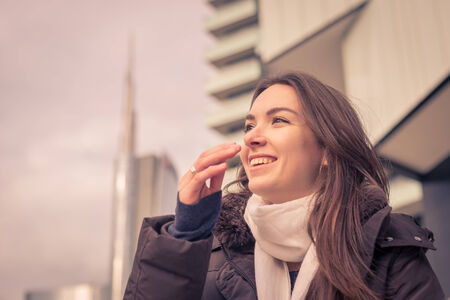 Young beautiful girl with long hair posing in the city streetsの写真素材