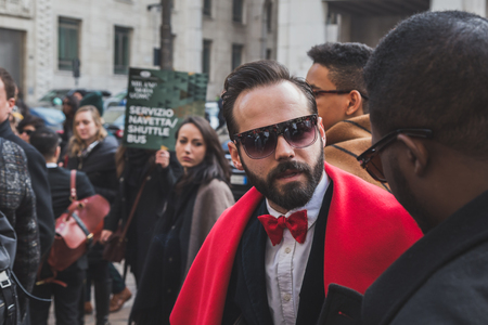 MILAN, ITALY - JANUARY 18: People gather outside Ferragamo fashion show building for Milan Men's Fashion Week on JANUARY 18, 2015 in Milan.のeditorial素材